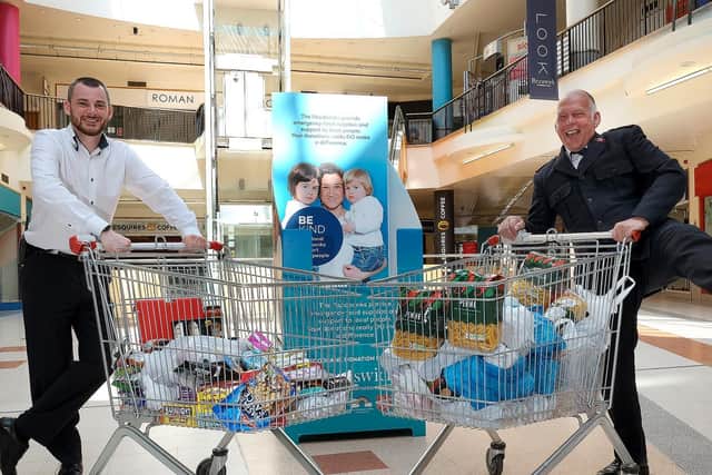 Major Steve Noble, Citadel Salvation Army, Scarborough accepts the donation from Graham Parsons, Brunswicks Facilities Manager, to launch the Centres Just Giving Food Bank Appeal.
