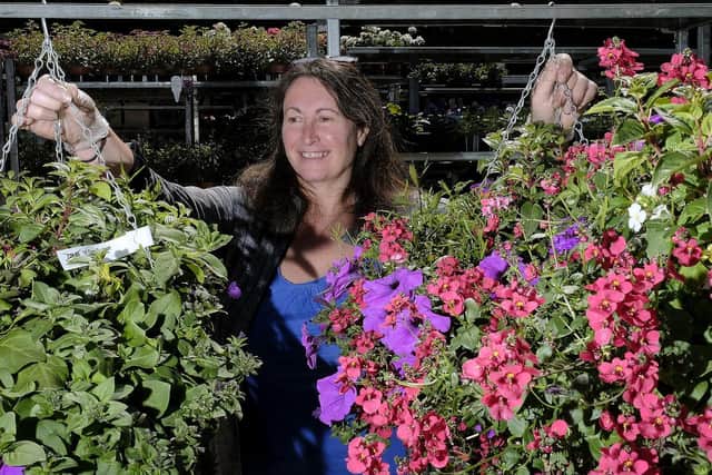 Burniston Garden Centre co-owner Deborah Collins tending to the plants