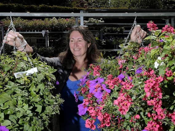 Burniston Garden Centre co-owner Deborah Collins tending to the plants