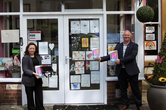 Scarborough Freemason Karl Ward (right) presents the tablets to Anne Brand (Saint Cecilia’s Care Group).