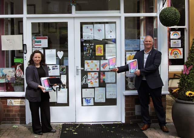 Scarborough Freemason Karl Ward (right) presents the tablets to Anne Brand (Saint Cecilia’s Care Group).