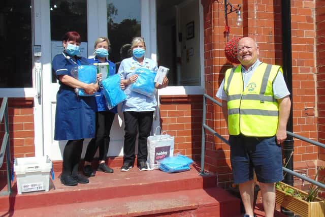 Filey Lions PresidnetJohn Casey with care home staff receiving the PPE