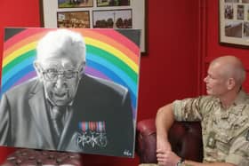 Lt. Col. Rich Hall admires the portrait after the presentation.