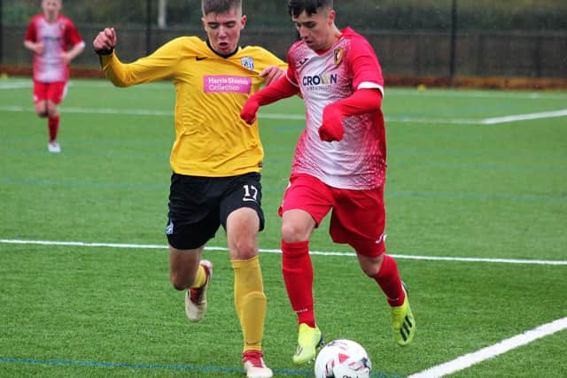 Edgehill Reserves youngster Josh Fergus gets away from Scalby Reserves Brad Smith,