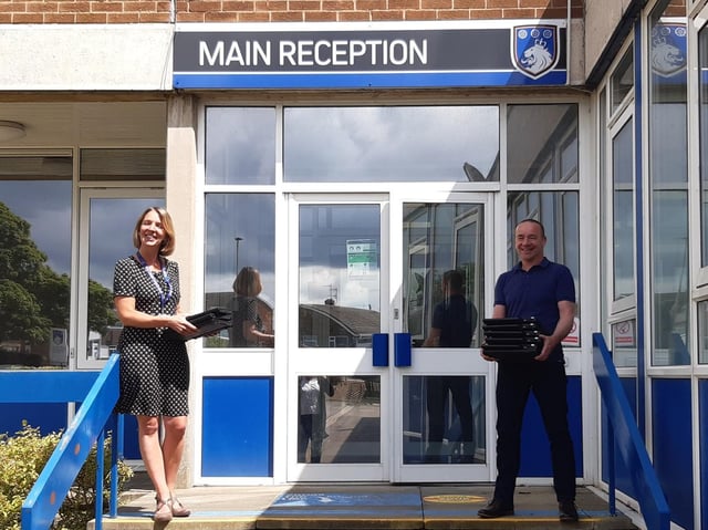 George Pindar School Principal Lesley Welsh with Matt Parsons, General Manager, External Affairs, Anglo American, with the donated laptops.