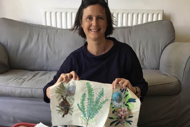 Outreach officer Miriam Shone with some of the embroidered plants.