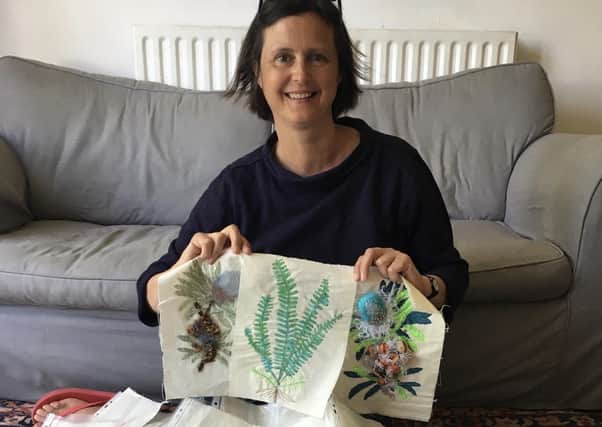 Outreach officer Miriam Shone with some of the embroidered plants.