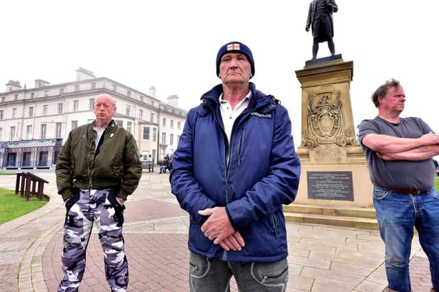 Locals guard the Captain Cook statue in Whitby fearing it may be vandalised by protesters. Picture: Richard Ponter