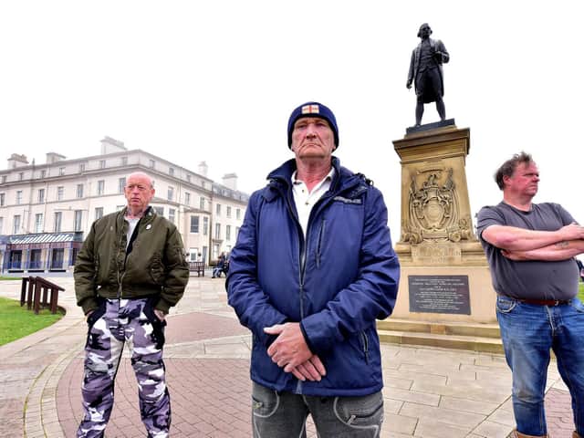 Locals guard the Captain Cook statue in Whitby fearing it may be vandalised by protesters. Picture: Richard Ponter