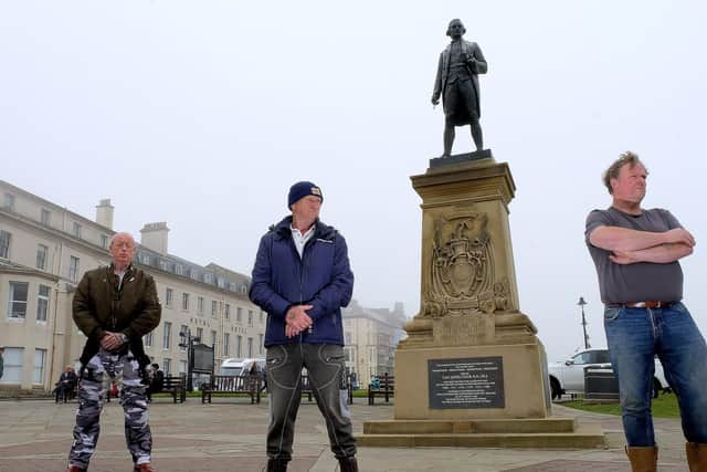 Locals guard the Captain Cook statue in Whitby fearing it may be vandalised by protesters. Picture: Richard Ponter