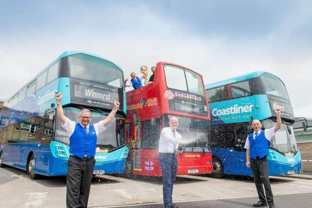Duty Manager Eamonn Wall and Engineer Darren Tempest lift the World Cup with General Manager Ben Mansfield popping the champers with drivers Les Timmins (L) and Alan Gibson (R).