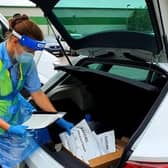 A county council driver prepares to deliver tests for the care sector satellite testing unit in Scarborough.