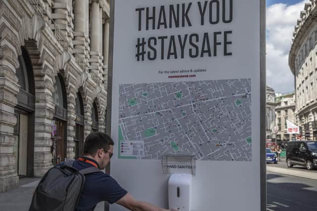 A hand sanitiser in use in London.