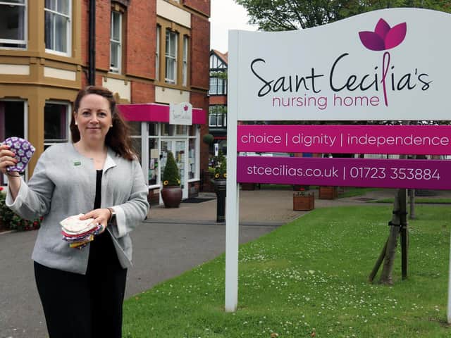 Anne Brand, Executive Administrator with Saint Cecilias Care Group, with some of the donated face coverings.