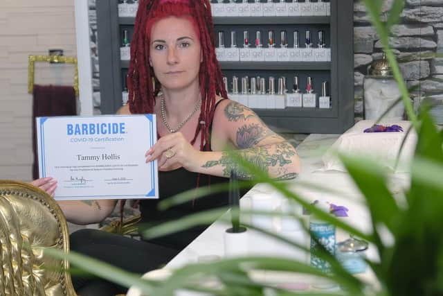 Tammy Hollis with her Barbicide Covid-19 certificate