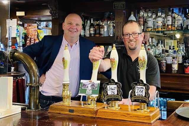 Chris Price and Piglet from the North Yorkshire Moors Railway pull a pint of ‘We’ll Steam Again’ at Cropton Brewery’s base The New Inn.