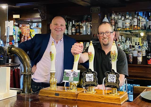 Chris Price and Piglet from the North Yorkshire Moors Railway pull a pint of ‘We’ll Steam Again’ at Cropton Brewery’s base The New Inn.