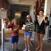 Valentine Long, Winnie Long and mum Kirstie Long pick up their book bundles at Whitby Library.