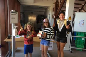 Valentine Long, Winnie Long and mum Kirstie Long pick up their book bundles at Whitby Library.