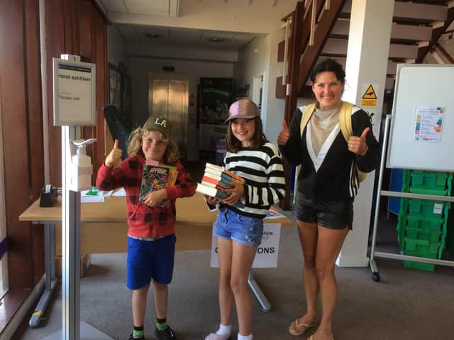 Valentine Long, Winnie Long and mum Kirstie Long pick up their book bundles at Whitby Library.