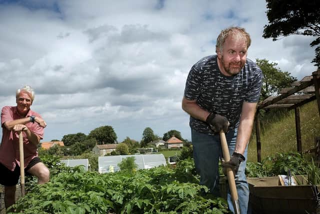 Alan and Paul work in the garden