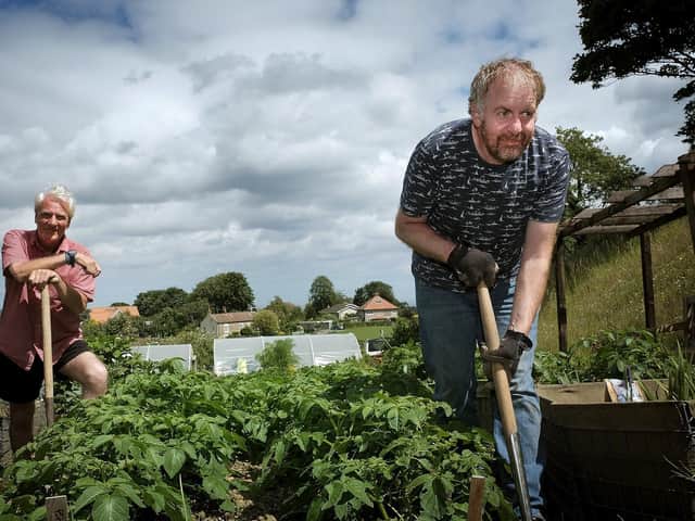 Alan and Paul work in the garden