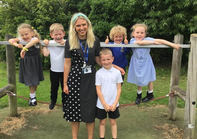 Award-winner Miss Jay Fenby with some of the youngsters of Stakesby School.