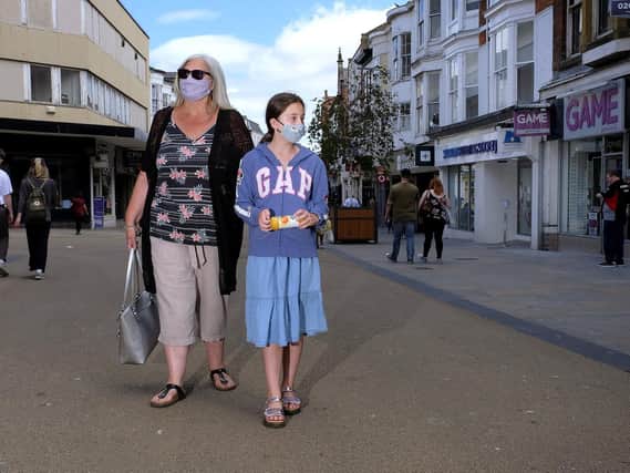 Shoppers wearing masks in Scarborough's town centre - a grandmother and granddaughter walk along Westborough.
