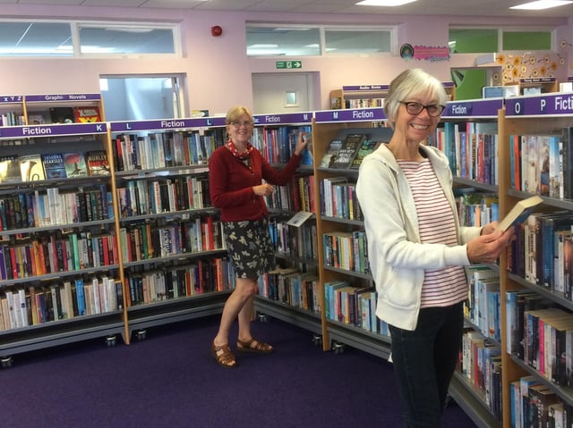 Library volunteers Jacqueline Byers (front) and Jane Pottas.