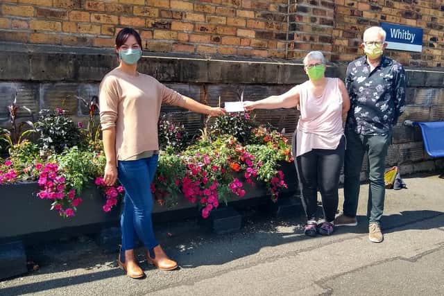 Sally Michulitis presenting the cheque to Amanda and Steve Smith of Whitby in Bloom