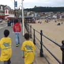 Kieran and his brothers walking along the seafront