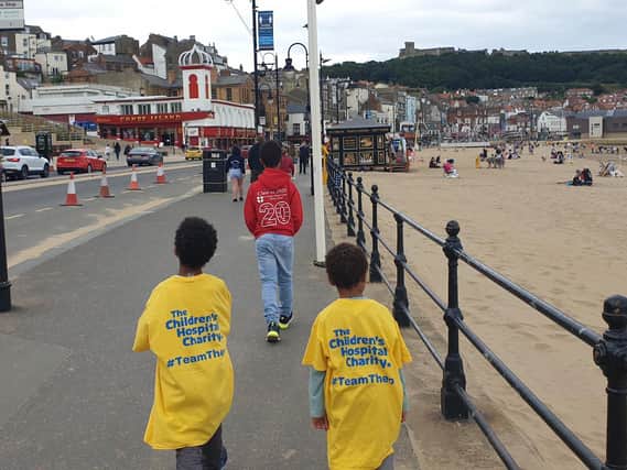 Kieran and his brothers walking along the seafront