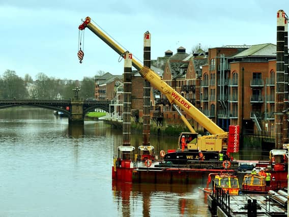 A crane manouvres onto a barge onto the River Ouse at Queens Staith in York in preparation for work on the Guildhall. Photo: Gary Longbottom