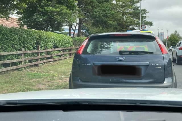 The blue Ford Focus is stopped.