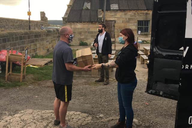 A keyworker receiving a box of Whitby Brewery's finest beer
