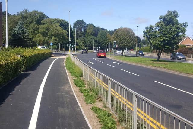 The two lanes on Scalby Road, near the junction with Woodlands Drive, merge into one beyond the traffic lights
