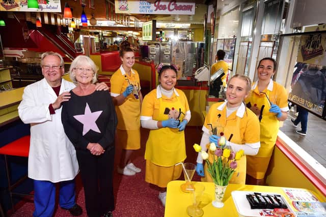 Giulian and Theresa Alonzi with staff, celebrating the 75th anniversary.