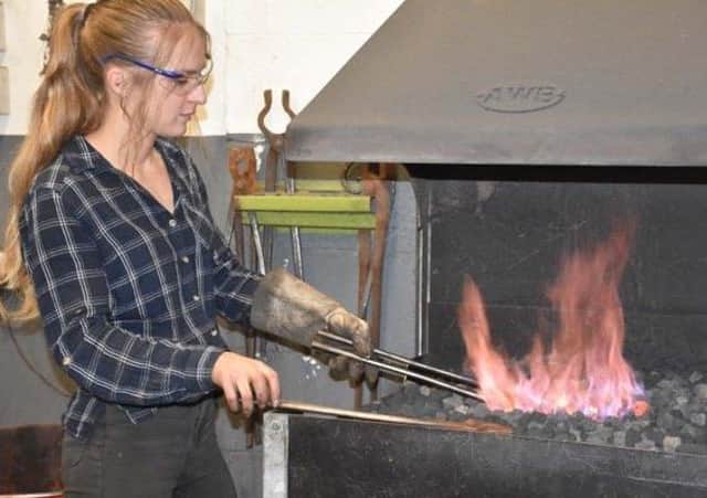 Katie Ventress using her forge at her Hinderwell studio.