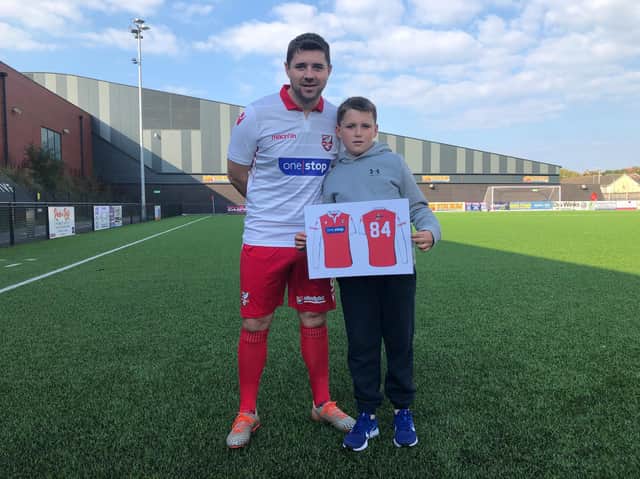 Boro player-coach and club captain Ryan Blott wears the new third shirt and competition winner Lennon Slaughter shows off the first-team kit he designed for the NPL Premier club