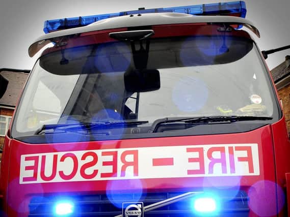 Firefighters were called after a parked car was hit by a motorist.