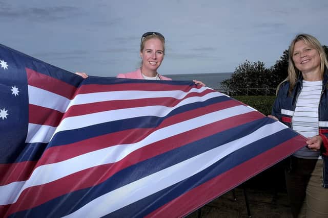 Fiona Clibbens and Kim Hodgson with the flag from the Bonhomme Richard.