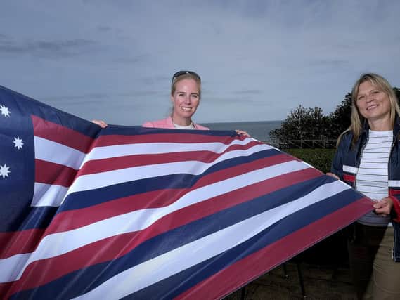 Fiona Clibbens and Kim Hodgson with the flag from the Bonhomme Richard.