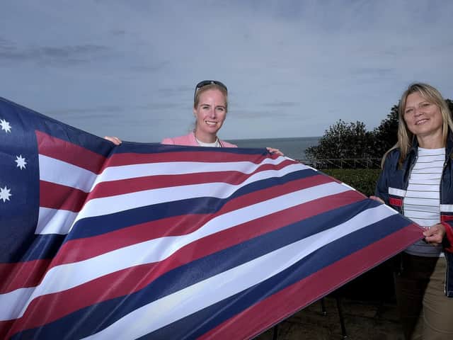 Fiona Clibbens and Kim Hodgson with the flag from the Bonhomme Richard.