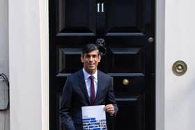 Chancellor of the Exchequer Rishi Sunak holds a copy of his Winter Economy Plan outside No 11 Downing Street before heading for the House of Commons to give MPs details of his Winter Economy Plan. Photo: PA