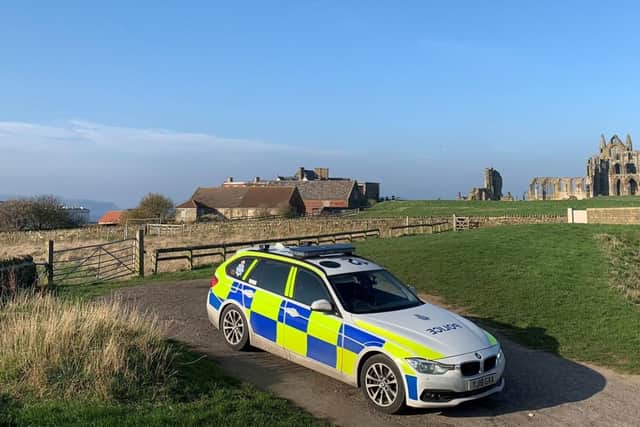 A North Yorkshire Police car on patrol at the ruins of Whitby Abbey. The Benedictine abbey - rebuilt in the 1220s - thrived for centuries as a centre of learning, before its destruction by Henry VIII in 1540 during the Dissolution of the Monasteries: