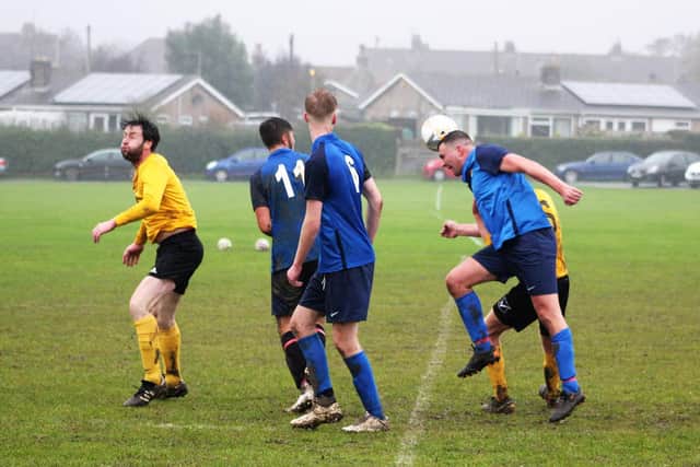 Edgehill Reserves' Andy Noon wins a header
PHOTO BY ALEC COULSON
