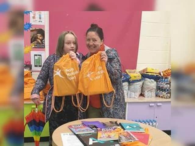 Mum Tracy and daughter Faith collect Summer Superstars packs at Gallows Close Community Centre in Scarborough