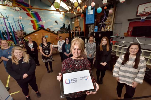 The Happy Futures team proudly display their certificate