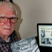 Author Mike Wilson is pictured with his new publication.