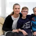 Issac Brown at home in Scarborough, pictured with mum Lauren Wilson and sister Lilly Brown.